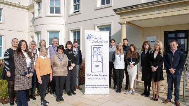 Clowes Developments staff stood outside with a mind charity banner