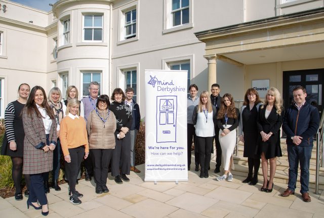 Clowes Developments staff stood outside with a mind charity banner