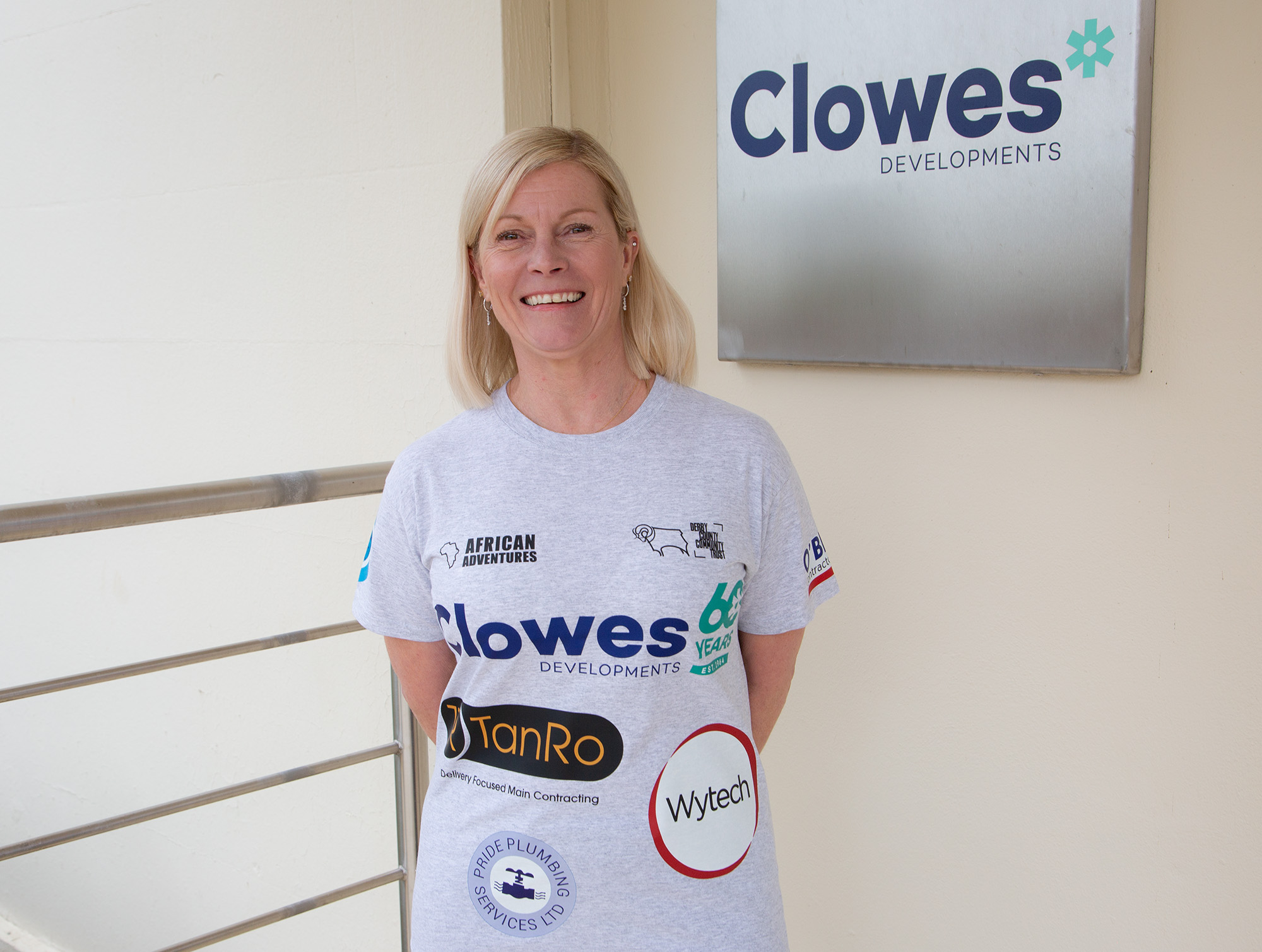 Clowes Developments Amanda Page Rams in kenya woman wearing grey tshirt with logos on